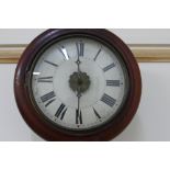 An early 20th century chain driven wall clock, the circular painted face with Roman numerals,