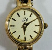 A 9 carat gold ladies bracelet watch, the circular face with gilt baton numerals and hands,