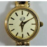 A 9 carat gold ladies bracelet watch, the circular face with gilt baton numerals and hands,