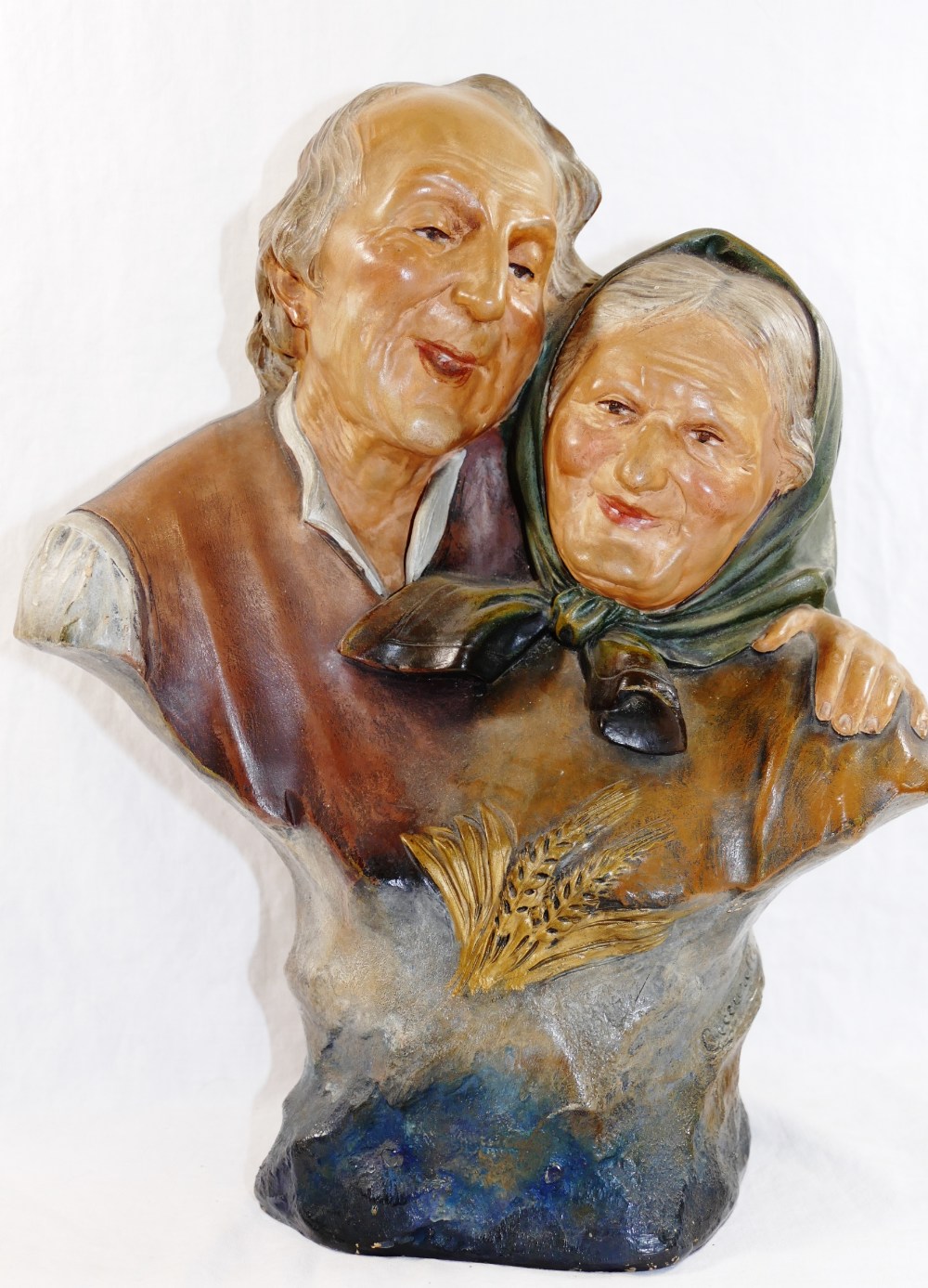 Ezio Ceccarelli (1865-1927), a painted pottery group of an elderly peasant couple laughing,