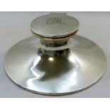 A large silver capstan inkwell, initialed 'CW' to the lid, with glass well and loaded base,