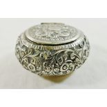 An Indian silver coloured metal oval snuff box, with embossed decoration and hinged lid, 3.