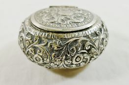 An Indian silver coloured metal oval snuff box, with embossed decoration and hinged lid, 3.