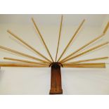 An early 20th century wall mounted folding airer, the 10 sticks each 54cm long,