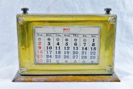 An early 20th century oak desk calendar,