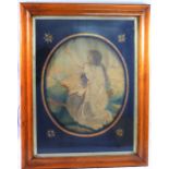 A 19th century oval embroidered silk picture of a young woman kneeling with her arms aloft,