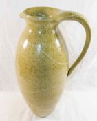 Susan Cupitt (20th/21st Century)+ Tall stoneware pottery jug with mottled green glaze and porcelain