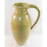 Susan Cupitt (20th/21st Century)+ Tall stoneware pottery jug with mottled green glaze and porcelain