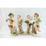 Four Naples porcelain figures of putti, depicted with a sheath of corn, a basket of flowers, wine,
