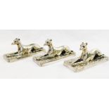 Three Elkington and Co. silver plated recumbent greyhound paperweights, 9.
