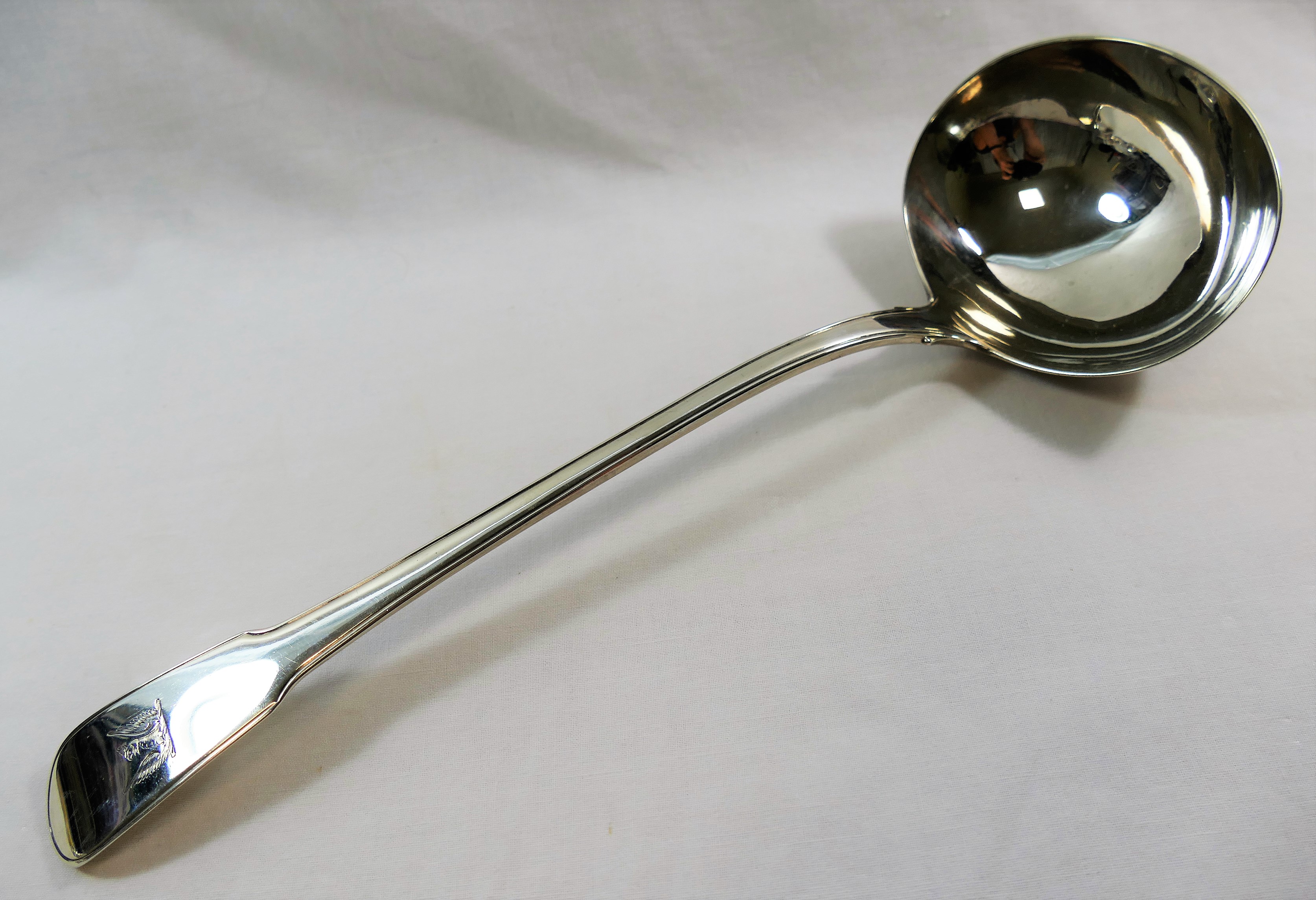 A George III silver fiddle and thread pattern soup ladle,