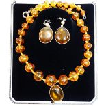 A modern amber bead necklace, with silver coloured metal clasp, 65cm long,
