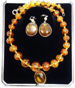 A modern amber bead necklace, with silver coloured metal clasp, 65cm long,