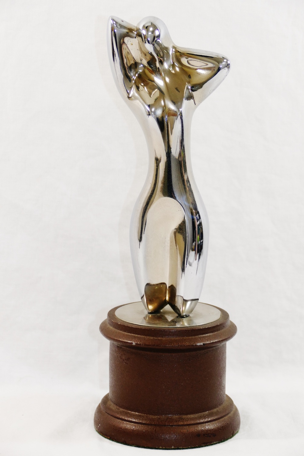 A chrome plated figure of a nude, in a similar pose to Man Ray's 'Herma', unsigned, 20cm high,