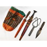 Four tribal items comprised of two steel bladed daggers in leather sheaths, a pair of scissors,