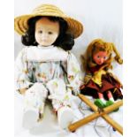 A Pelham puppet 'Gretel' 31cm long, and a cloth doll, with fabric covered moulded face,