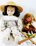 A Pelham puppet 'Gretel' 31cm long, and a cloth doll, with fabric covered moulded face,