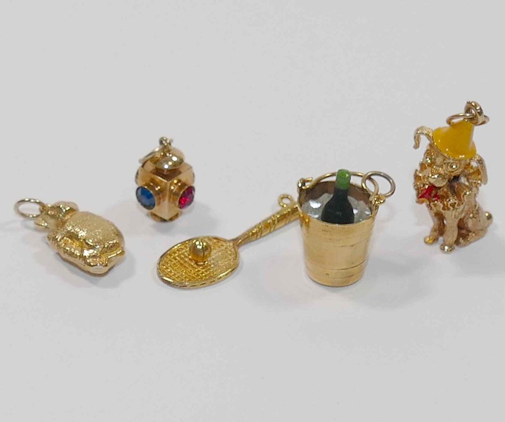 Five 9 carat gold charms, comprised of a lantern, tennis racket, koala, - Image 2 of 2