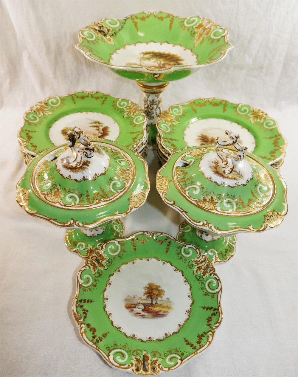 A Victorian Davenport porcelain dessert service, decorated with hand painted rural landscapes,