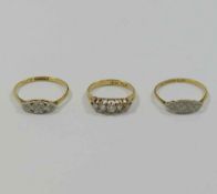 Three early 20th century diamond rings, two stamped '18CT and PLAT',