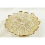 An Indonesian silver coloured metal circular flower head filigree dish, raised on three feet, 10.