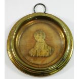 A 19th century miniature gilt metal relief bust of Sir Robert Peel, mounted on beige velvet,