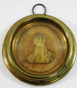 A 19th century miniature gilt metal relief bust of Sir Robert Peel, mounted on beige velvet,