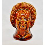 A 19th century treacle glazed stoneware money box in the form of a grotesque woman's head,