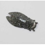 A Kenneth Jay Lane cicada brooch, set with paste and hematite, maker's stamp to underside, 8.