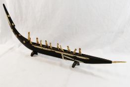 A 19th century or earlier baleen and bone model of a boat with figures, 50.