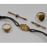 A 9 carat gold tigers eye set ring, 9g gross, a gem set yellow metal snake head ring (at fault), 3.