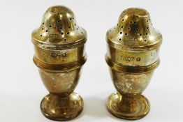 A pair of silver pepperettes, Chester 1910, 7cm high, combined weight 1.