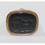 A 19th century gold seal, set with a black onyx panel intaglio carved with a mare and foal,