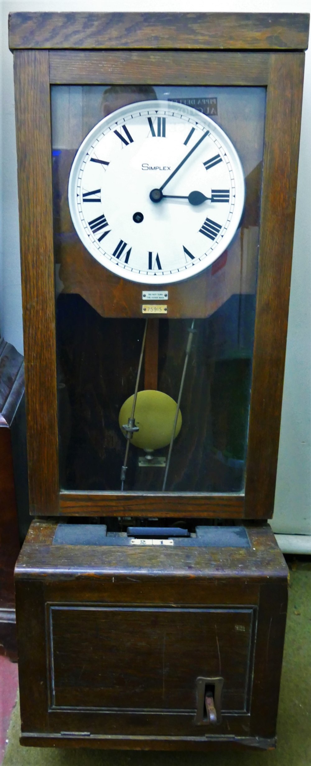 A Simplex oak cased clocking in clock, numbered 75915,