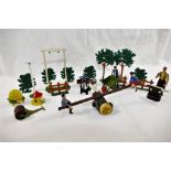 A collection of Britains die cast toys including a boy and a girl on a see saw, a dovecot,