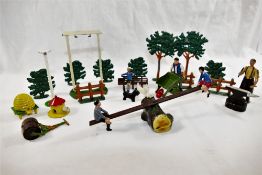 A collection of Britains die cast toys including a boy and a girl on a see saw, a dovecot,