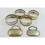 A set of four silver napkins rings with pierced Greek key decoration,