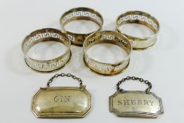 A set of four silver napkins rings with pierced Greek key decoration,