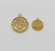 A 9 carat gold circular Saint Christopher pendant, set within a yellow metal wedding band,