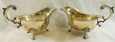 A pair of George V silver gravy boats, Sheffield 1918, with wavy rims and acanthus scroll handles,