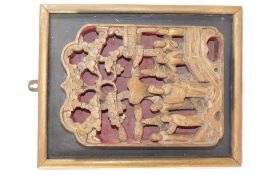 A 19th century Chinese carved and pierced panel, depicting a gathering of men by a bridge,