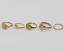 Four 9 carat gold signet rings and a 9 carat gold wedding band,