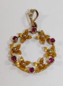 An early 20th century yellow metal circular pendant in the form of a wreath,