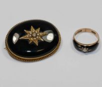 A Victorian 15 carat gold and black onyx set oval mourning brooch, the centre set with gold,