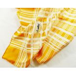 An Yves Saint Laurent yellow and white silk scarf with crossed thread pattern and YSL monogram to