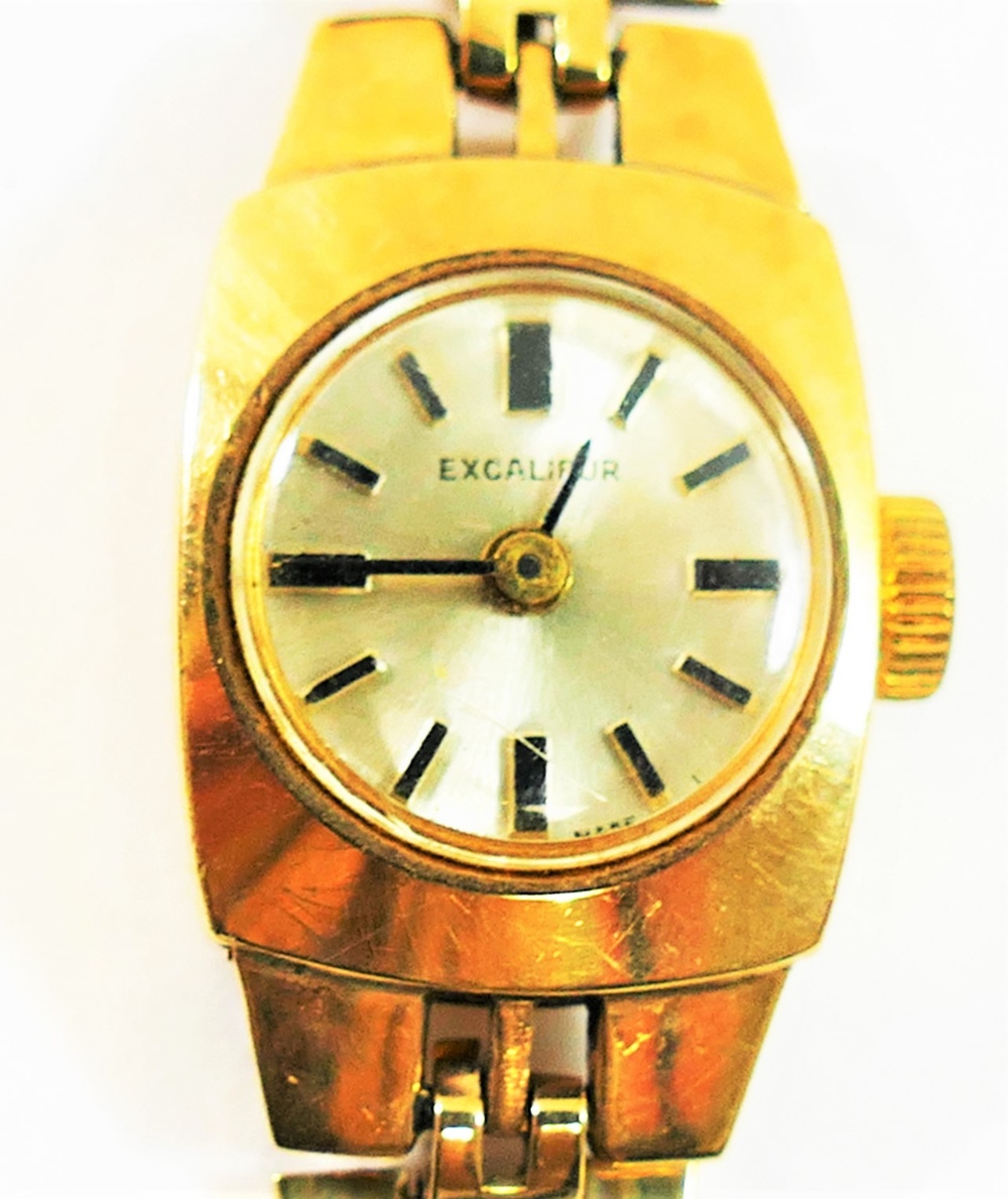 A ladies 'Excaliber' 9 carat gold bracelet watch, the round face with baton numerals,