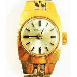 A ladies 'Excaliber' 9 carat gold bracelet watch, the round face with baton numerals,