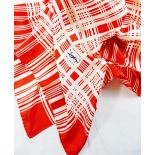 An Yves Saint Laurent red and white silk scarf with crossed thread pattern and YSL monogram to