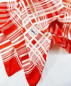 An Yves Saint Laurent red and white silk scarf with crossed thread pattern and YSL monogram to