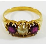 A yellow metal garnet and mabè pearl three stone ring, the stones within claw setting,
